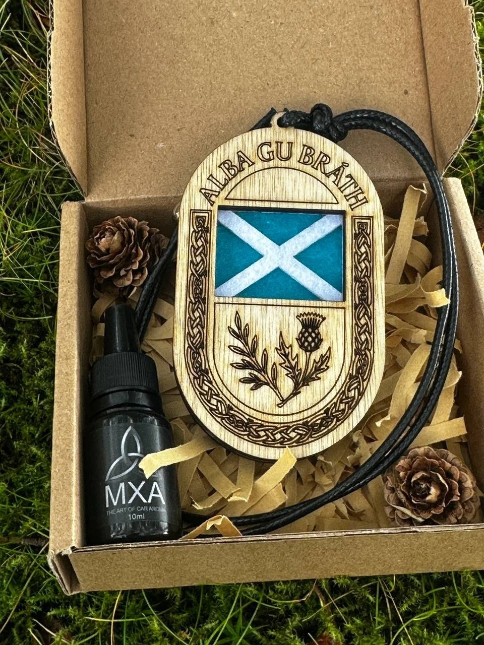 Close detail of the Scottish flag, thistle and Celtic border engraved into a birch wood diffuser